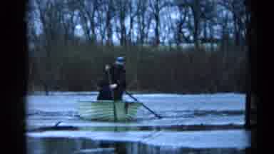 Wauconda Illinois USA (1961): A Man Standing In A Rowboat Thrusts His Oar Into