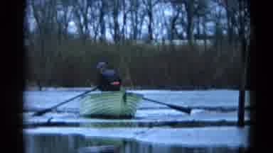 Wauconda Illinois USA (1961): A Man In A Boat With Two Oars Stands Up From Sitting