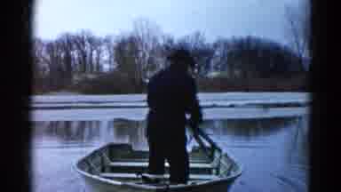 Wauconda Illinois USA (1961): Fisherman Embarking Small Rowboat Lake Bare Trees