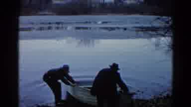 Wauconda Illinois USA (1961): Two Men Push A Boat Into A Body Of Water