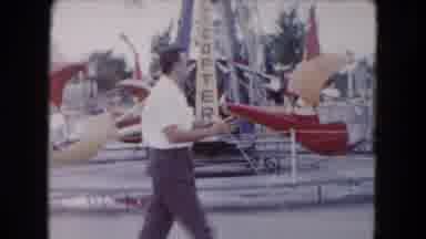 South Carolina USA (1961): Man Walking His Dog Through A Small Carnival Towards
