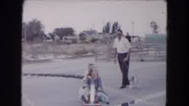 South Carolina USA (1961): A Two Girls Driving A Train On Track And A Man Take Dog