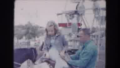 South Carolina USA (1961): Man Wearing Blue Shirt Places Girl Wearing White Dress