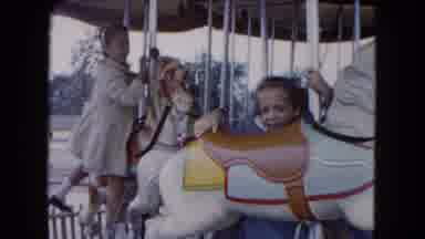 South Carolina USA (1961): Two Young Girls Climb Up On Horses At A Carousel