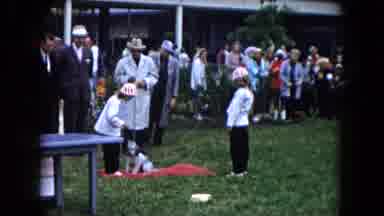 South Carolina USA (1961): Many People Standing Around A Patch Of Grass Where Two