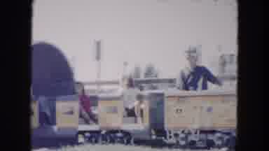 South Carolina USA (1961): Kids Riding Train At Amusement Park Train Comes Out Of