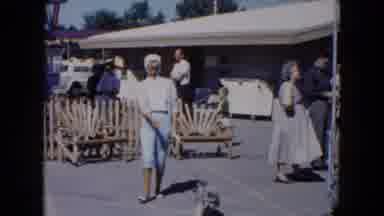 South Carolina USA (1961): A Lady Walking Her Dog At Some Sort Of Carnival Or Fair