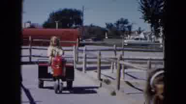 South Carolina USA (1961): Young Blond Girl Is Driving Toy Tractor On A Sunny Day