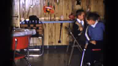 South Carolina USA (1961): Two Little Boys Running Around A Chair Playing Musical