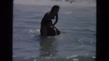 South Carolina USA (1961): Woman Climbing On A Mans Shoulders Standing In The
