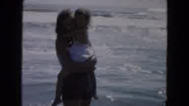 South Carolina USA (1961): A Woman And Her Child Playing In The Grey Ocean