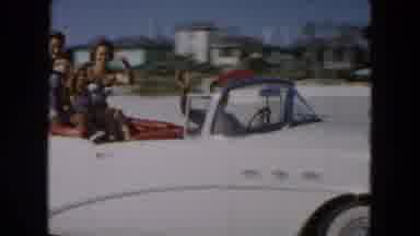 South Carolina USA (1961): Man Rides A Car Along The Beach With His Family On A