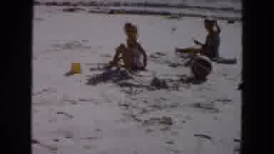 South Carolina USA (1961): 3 Kids Are Playing One Lady Seeing In Beach