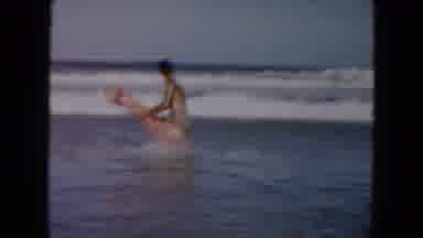 South Carolina USA (1961): Man With A Light Pink Float In The Ocean Trying To Ride