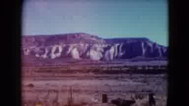 Nevada USA (1961): Mountains Behind An Area That Has Dirt And Patches Of Grass