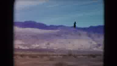 Nevada USA (1961): Passing View Of Mountains Against Blue Sky On A Sunny Day