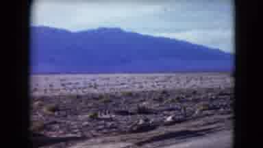 Nevada USA (1961): Slow Moving View Of A Desert Road With A Small Mountain Off In