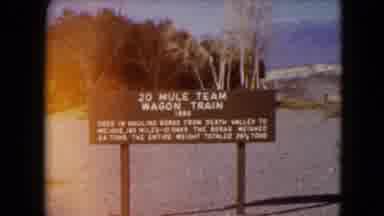 Nevada USA (1961): Old Wagon Train On Display Beside A Sign On A Beach