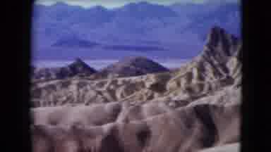 Nevada USA (1961): Brown Rocks And Mountains Stand Tall Against The Blue Sky