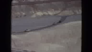Nevada USA (1961): The Cars Are Going On The Road Near The Rock Mountain