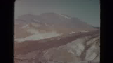 Nevada USA (1961): Scenic View Of A Snowy Mountain Range And Rocky Valley