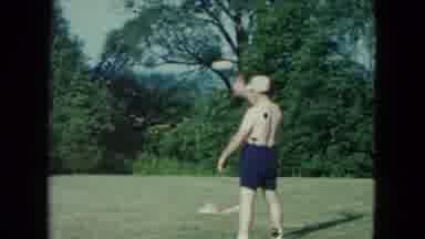 Nevada USA (1961): A Shirtless Man Wearing Shorts Throws A Baseball Followed By