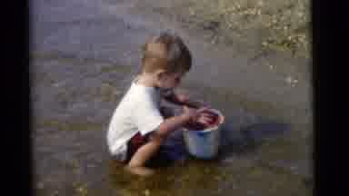 Camden New Jersey USA (1961): Child Fills Bucket With Mud While Playing In The