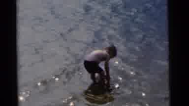 Camden New Jersey USA-1961: Young Boy Playing In Water With Red Bucket