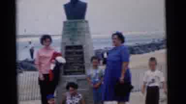 Camden New Jersey USA (1961): A Family Is Standing In Front Of A Plaque On A Beach
