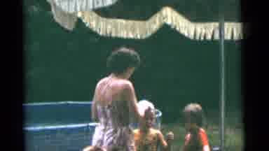 CAMDEN NEW JERSEY USA-1961: Mother Helps Child Put On Swim Cap As Others Gather By Pool
