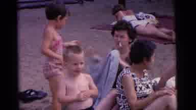Camden New Jersey USA (1961): Woman With Cigarette In Mouth Sitting On Beach Takes