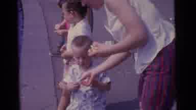 Camden New Jersey USA (1961): A Mother Give Some Food To Her Child He Through The