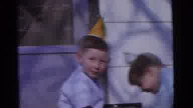 Camden New Jersey USA (1961): Two Boys Wearing Party Hats Play On The Ground Then