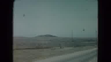 Nevada USA (1960): Grainy Film Footage Shot From A Vehicle Driving Down A Desolate