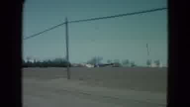 Nevada USA (1960): Driving Alongside Farmland Countryside With Power Lines And