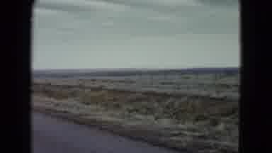 Nevada USA (1960): Camera In Road Panning Across Plain With Cloudy Sky And Car