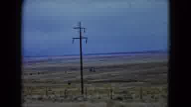 Nevada USA (1960): Driving Past Desolate Countryside That Has Telephone And Power