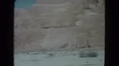 Nevada USA (1960): Two Sandstone Mountains And Two Signs As Filmed From A Moving