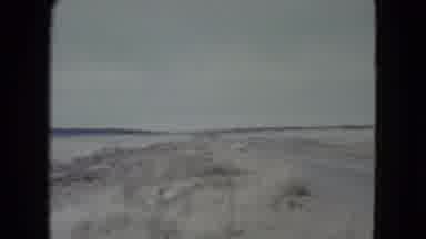 Nevada USA (1960): 1950s Station Wagon Drives Down Road In Sandy Beach Area Passes