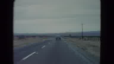 Nevada USA (1960): A Car Is Moving Through A Highway In A Vast Place