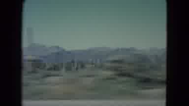 Nevada USA (1960): Driving Down A Long Isolated Road Headed Toward The Mountain