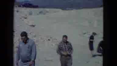 Nevada USA (1960): People Walking Around Scavenging At The Beach And Two Men