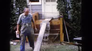 Wauconda Illinois USA (1960): Building Worker Walking Up Wooden Plank To The