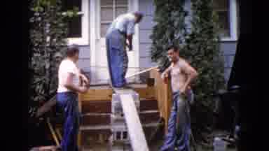 Wauconda Illinois USA (1960): Man Kneeling Onto A Porch As He Begins Working On