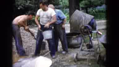 Wauconda Illinois USA (1960): Three Men Working Outdoors Shoveling Materials Into