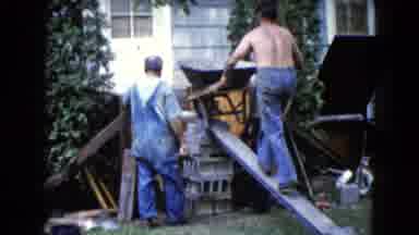 Wauconda Illinois USA (1960): Man With Wheelbarrow Walking Up A Wooden Plank While
