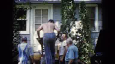 Wauconda Illinois USA (1960): A Man Bringing Outside A Wheelbarrow On A Wooden