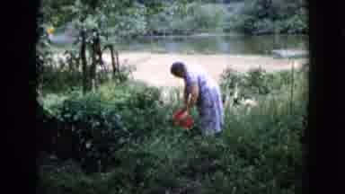 Wauconda Illinois USA (1960): Woman Carrying Bucket Of Water Near River