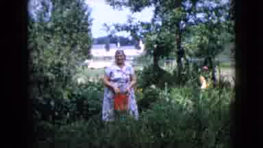 Wauconda Illinois USA (1960): An Old Fat Woman Is Walking With A Bucket Through