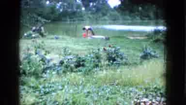 Wauconda Illinois USA (1960): A Person Is Walking To A Pond And Is Dumping A